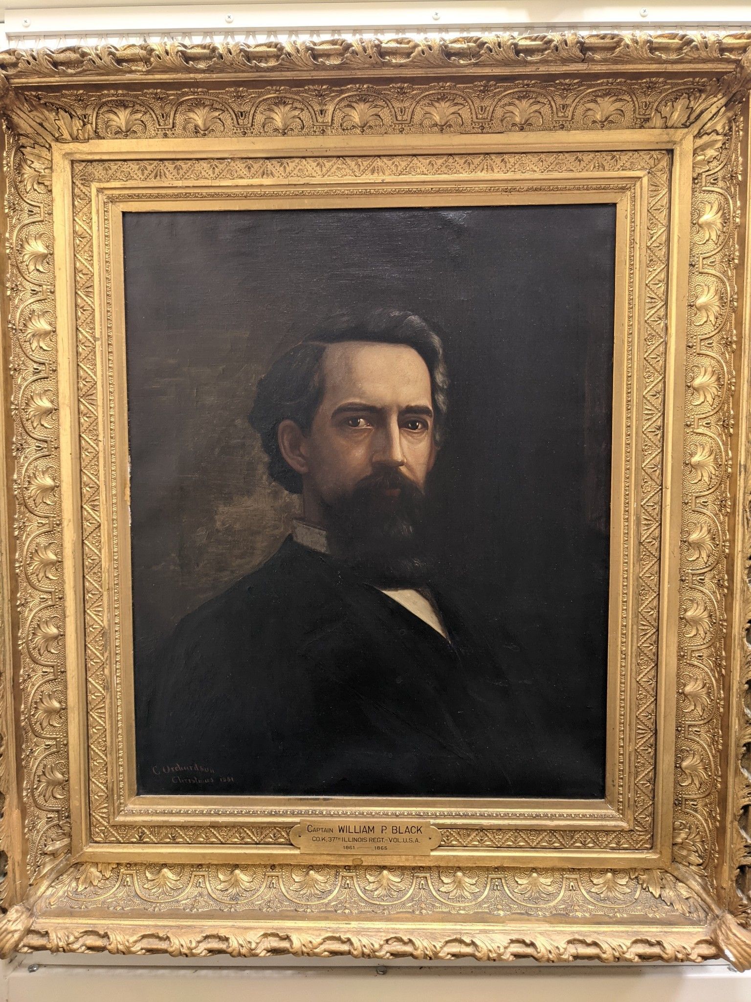 Portrait of William Black looking off to the right. The picture is set in a gold frame