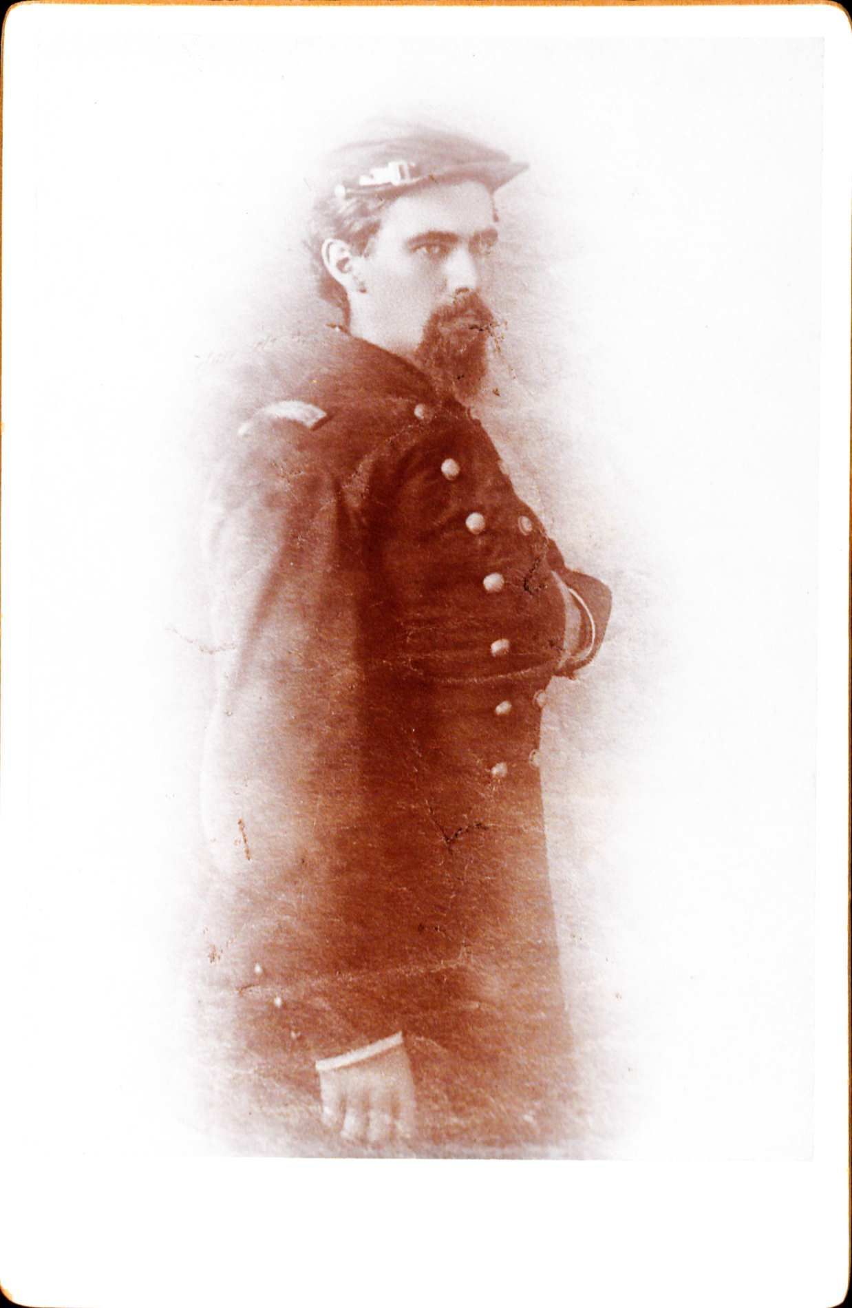 Portraitof John Black. He is wearing a mmilitary uniform standing facing the right with his left hand inside his jacket