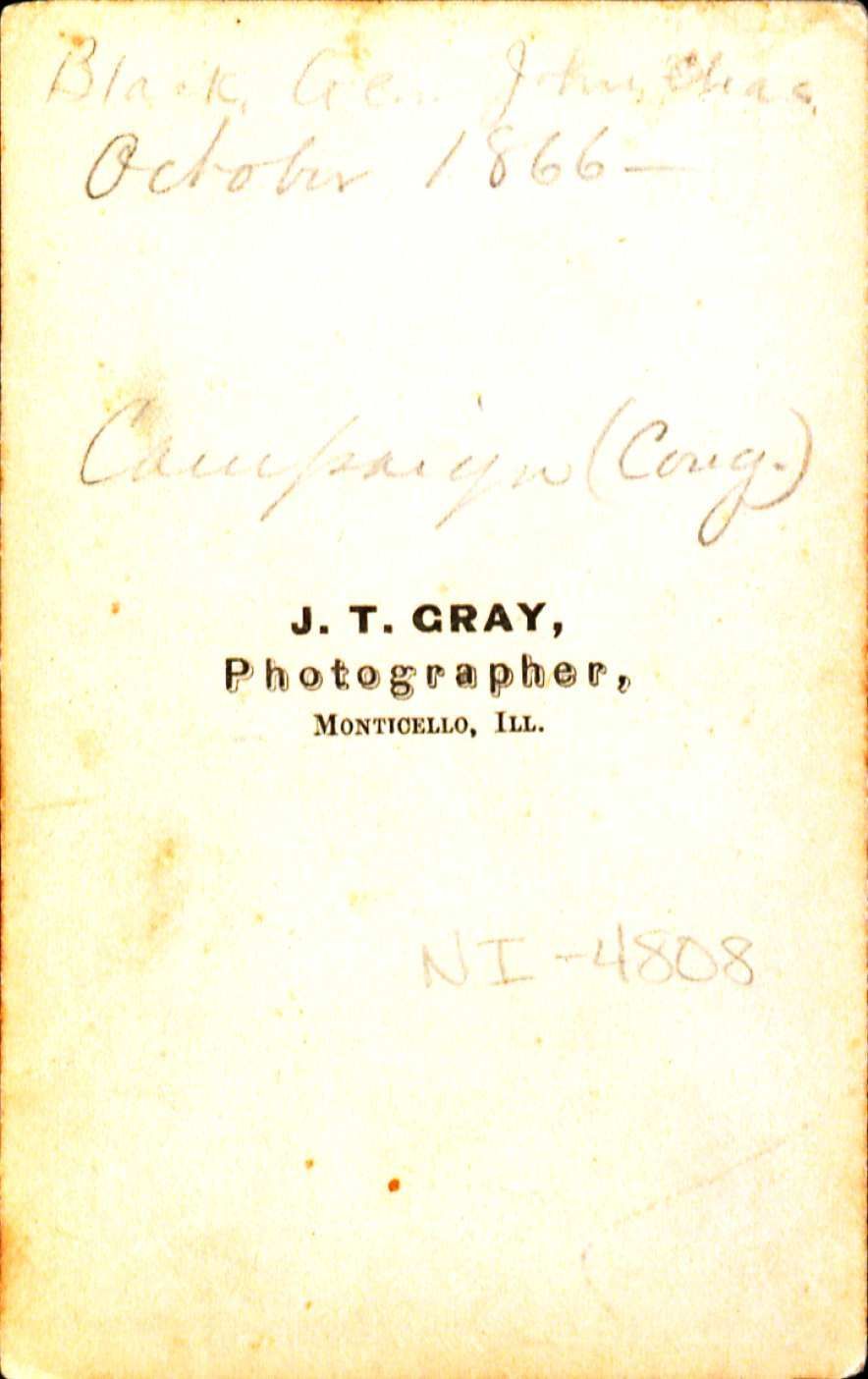 Picture of the back of a photo with the words J.T. Gray Photagraher and some faint hard to read cursive words