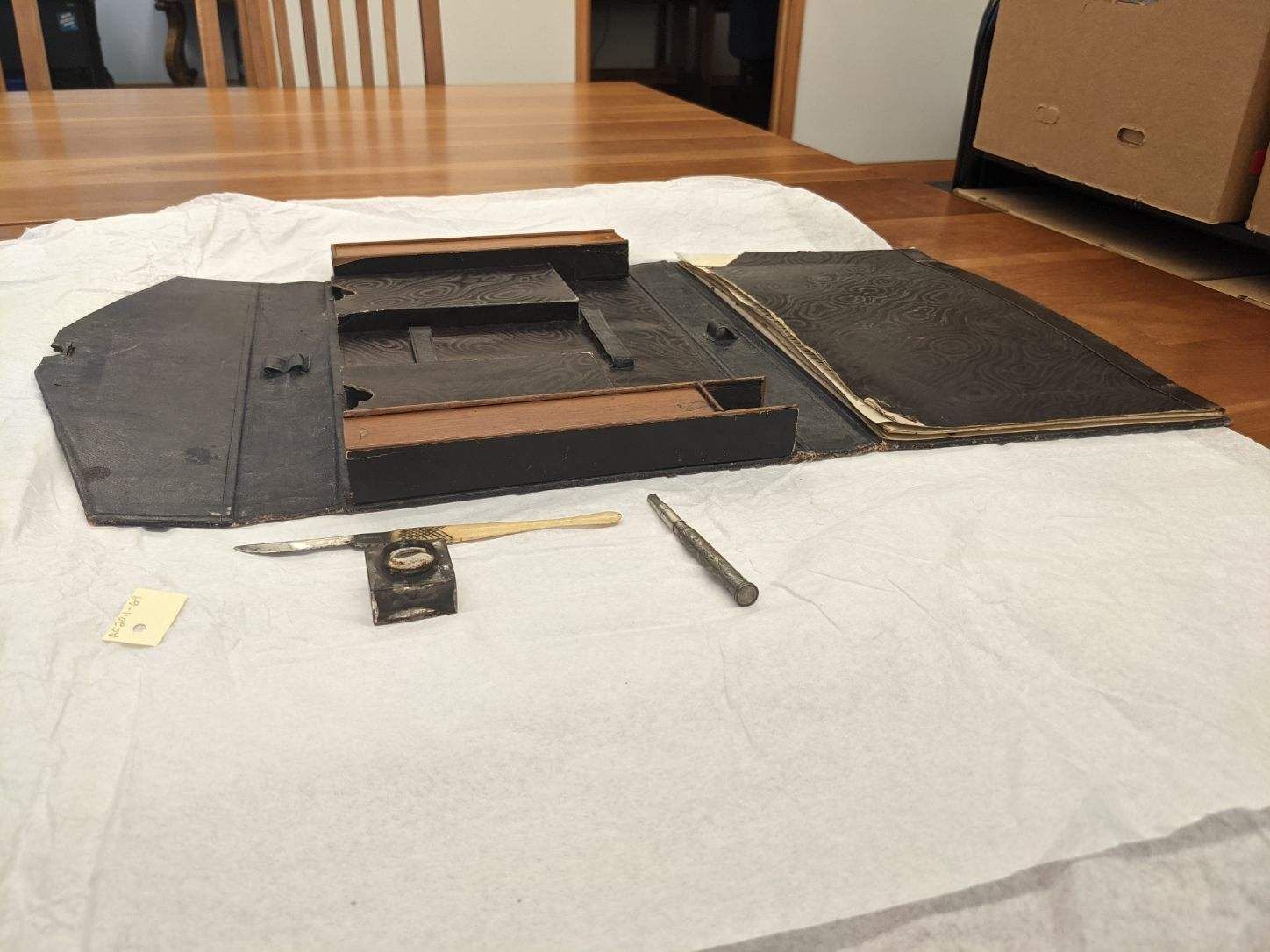 Picture of a fold out writing desk and pen and ink