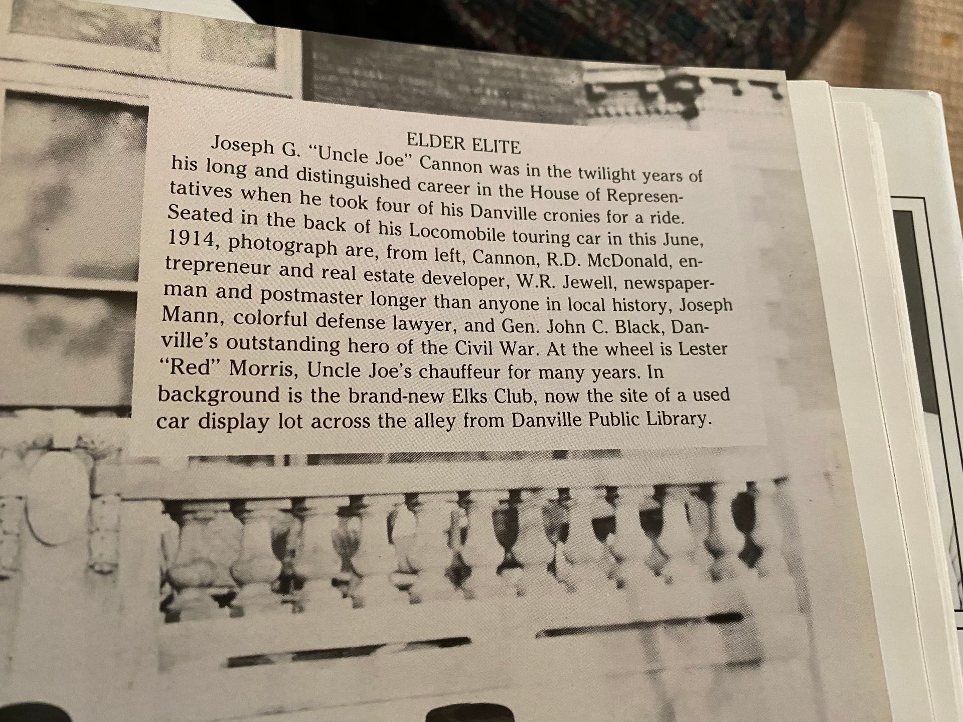 Picture of a newspaper or magazine clip with writing describing the picture of the 6 men in the car in a previous photo